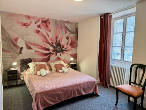 a bedroom with a pink flower painting on the wall at Douce Demeure - Hôtel-Restaurant de Mortemart in Mortemart