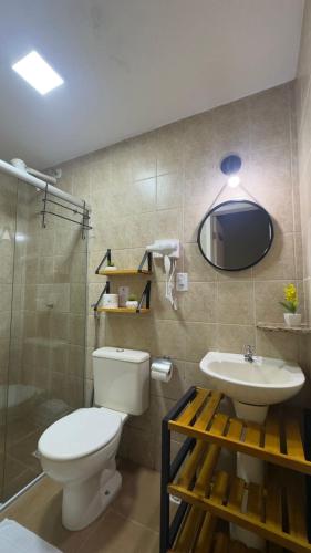a bathroom with a toilet and a sink at Estrela do Mar Paraty in Paraty