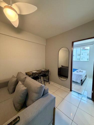 a living room with a couch and a table at Apto com 2 quartos e A/C no Centro e Santa Casa in Montes Claros