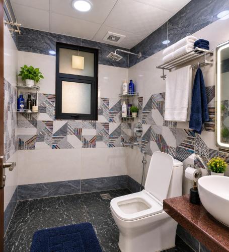 a bathroom with a toilet and a sink at Hotel Del Luna in Greater Noida