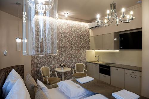 a kitchen with a bed and a table in a room at Nádor Rezidencia in Győr