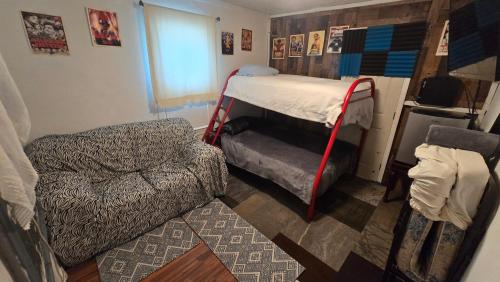 a bedroom with a bed and a chair and a couch at Grateful Hemphill in Atlanta