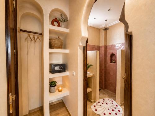 a bathroom with a walk in shower and a mirror at Wave chaser surfhouse morocco in Agadir