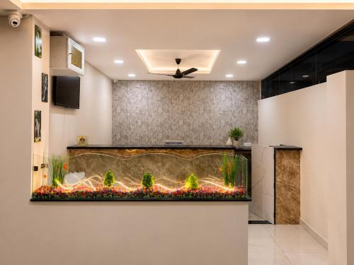 a large fish tank in a living room at Hotel GVR Prime in Guntūr