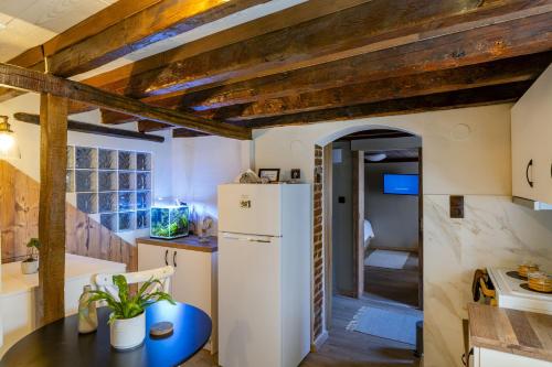 a kitchen with a white refrigerator and a table at Silk House in Souflíon