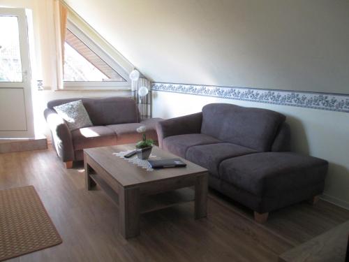 a living room with a couch and a coffee table at Ferienwohnung STEUERMANN in Werdum in Werdum
