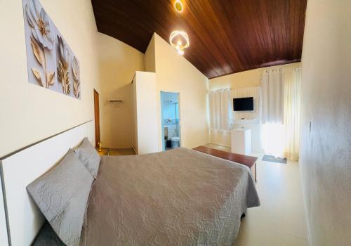 a bedroom with a bed in a room at Suíte Excellence - 02 in Pirenópolis