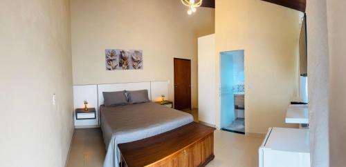 a bedroom with a bed in a room at Suíte Excellence - 02 in Pirenópolis