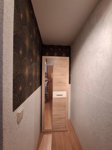 a hallway with a door and a person standing in a room at Stadtrand Hotel in Hagen