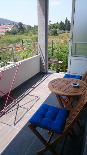 a patio with a table and chairs on a balcony at Guest House SAM-WATER in Đenovići