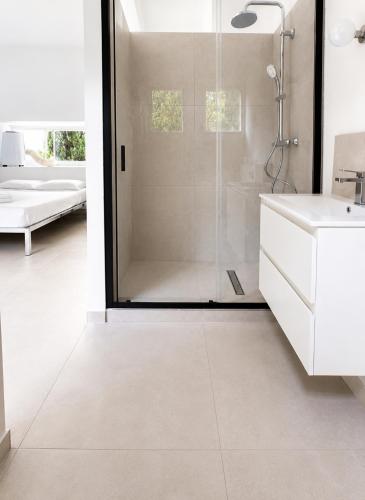 a white bathroom with a shower and a sink at ÉLÉGANT STUDIO et PARKING DANS BATIMENT HISTORIQUE in Saint-Tropez