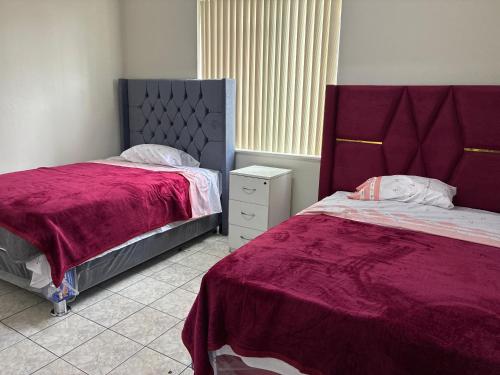 a bedroom with two beds with red comforter at Nazareth in Lima