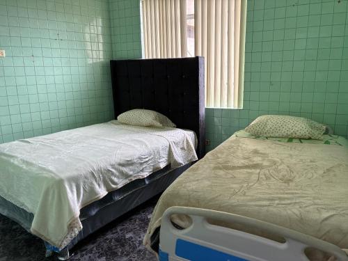 a hospital room with two beds and a window at Nazareth in Lima