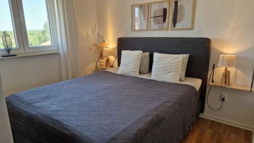 a bedroom with a blue bed with two pillows at Apartment Vanessa in Murine