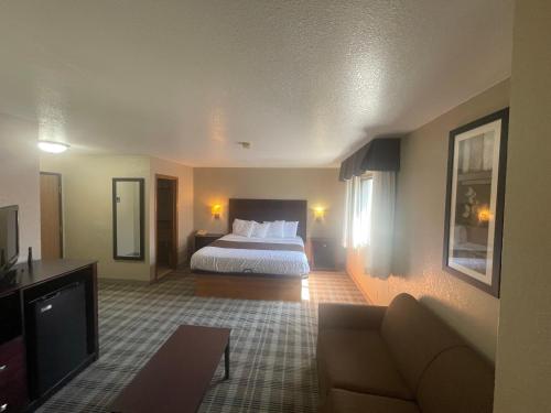 a hotel room with a bed and a couch at Quality Inn in Council Bluffs