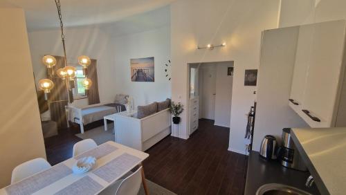 a kitchen and living room with a table and chairs at Apartment Vanessa in Murine