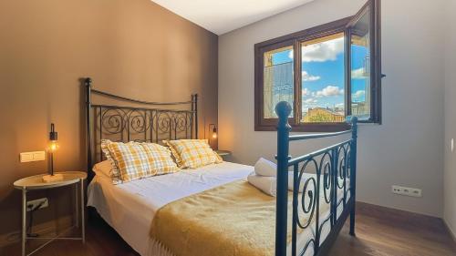 a bedroom with a bed and a window at Chez Bonheur in Osséja