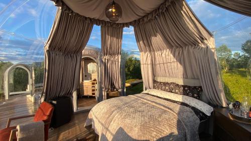 a bedroom with a bed and a large window at Hjertero - Hide Away Suite in Sortland