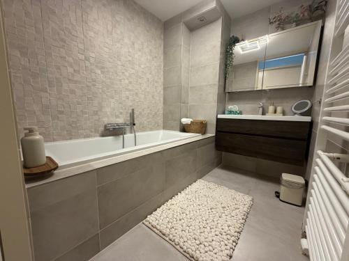 a bathroom with a bath tub and a sink at LUXURY Home Axel in Axel