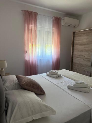 a bedroom with a bed with two towels on it at Villa Sveta Obitelj in Međugorje
