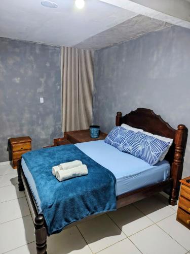 a bedroom with a bed with two towels on it at suíte feliz in Belém
