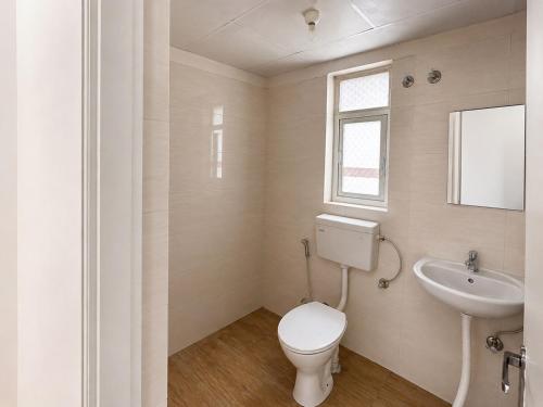 a bathroom with a toilet and a sink at Cinema Experience -Premium Studio in Karnal