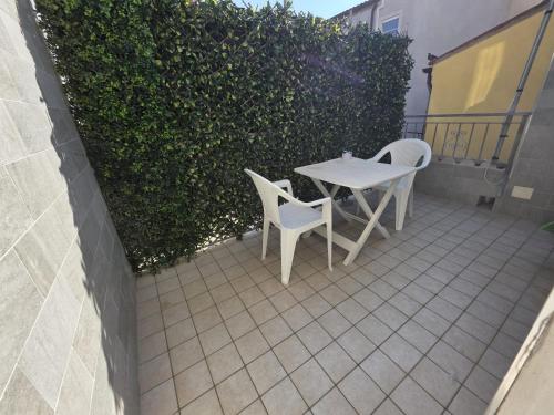 a table and two chairs sitting on a patio at CHIOGGIA PLAYA in Chioggia
