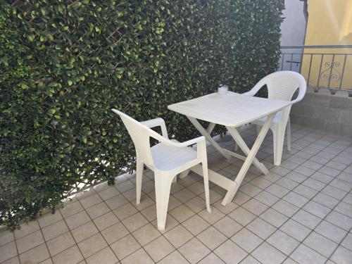a white table and two chairs on a patio at CHIOGGIA PLAYA in Chioggia