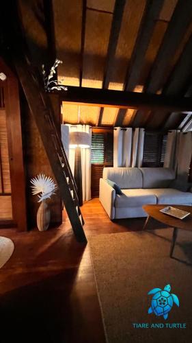 a living room with a couch and a table at Tiare and Turtle in Bora Bora