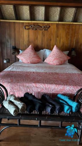 a bed with a rack of wine bottles on it at Tiare and Turtle in Bora Bora