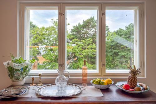 a table with plates of fruit in front of a window at Villa Maija 6 Topside in Hanko