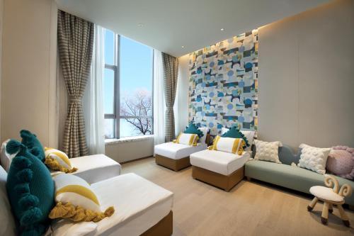 a childrens room with a couch and a room with a stuffed animal at Crowne Plaza Beijing Badaling by IHG in Yanqing