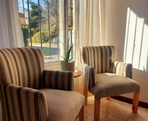 two chairs sitting in a room with a window at Sol de Monte in San Miguel del Monte