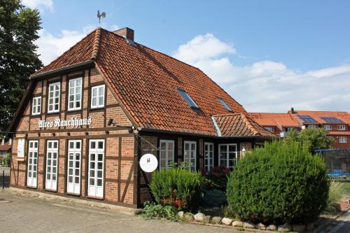 an old building with a red roof at Altes Rauchhaus in Ebstorf