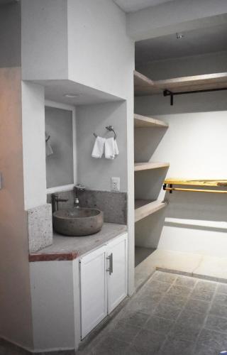 a bathroom with a sink and a counter with towels at Departamento Loro in Manzanillo