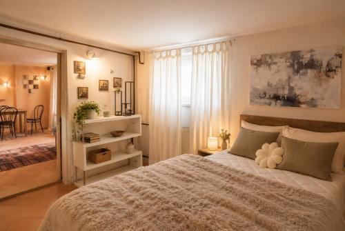 a bedroom with a large bed and a dining room at RoseArt Nest Studio in Ljubljana