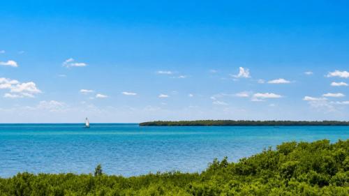 a sailboat in the middle of a large body of water at Luxurious 2BR 2BA Ocean Pointe Condo Tavernier Fl in Tavernier