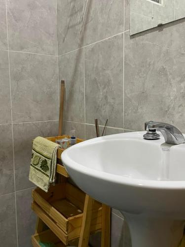 a bathroom with a white sink and a mirror at La Casita de Seclantás in Seclantás
