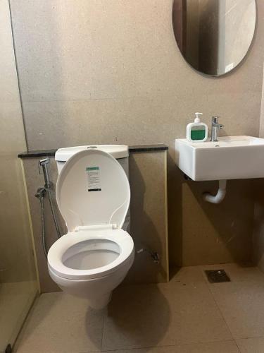 a bathroom with a toilet and a sink at Villa Grand Classic in Covelong