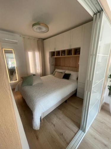 a bedroom with a bed and a large window at Le Grenier - Appartement vacances in Breil-sur-Roya