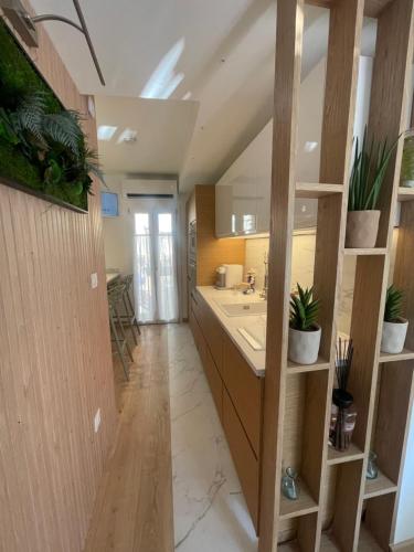 a large kitchen with a sink and a counter at Le Grenier - Appartement vacances in Breil-sur-Roya