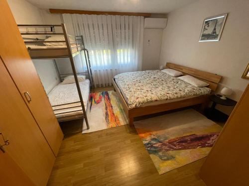 a small room with two bunk beds in it at Restful Garden Apartmants in Sarajevo