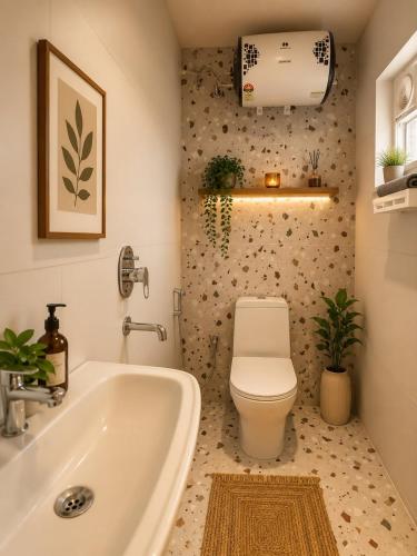 a bathroom with a white tub and a toilet at Luxurious boho pool villa nandi hills in Bangalore