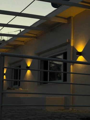 a house with lights on the side of it at Aigialos Villas with Private Beach by Hospi Living in Ferma