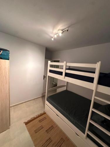 a bedroom with two bunk beds in a room at Agora resort north coast in Dawwār Abū Maḩrūs