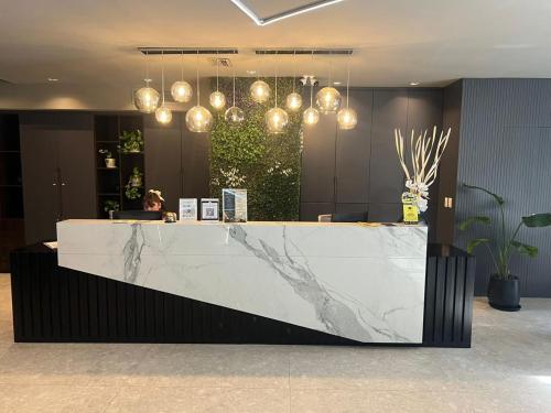 a lobby with a marble counter and lights at Empire Hotel Buenos Aires in Buenos Aires