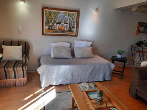 a room with a bed and a couch and a table at Piketberg Home with a View in Piketberg
