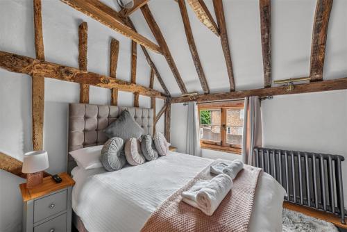 a bedroom with a bed with towels on it at Ye Olde Cottage in Crawley