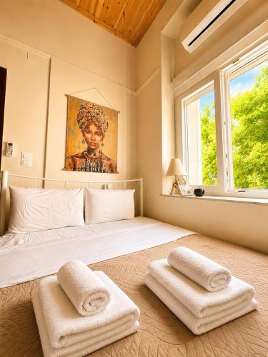a bedroom with a large bed with two towels on it at MARY'S HOUSE The lux terrace in Tripoli