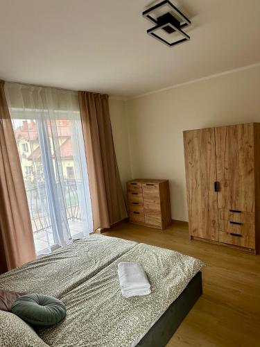 a bedroom with a large bed and a window at Nad Wadągiem in Kieźliny